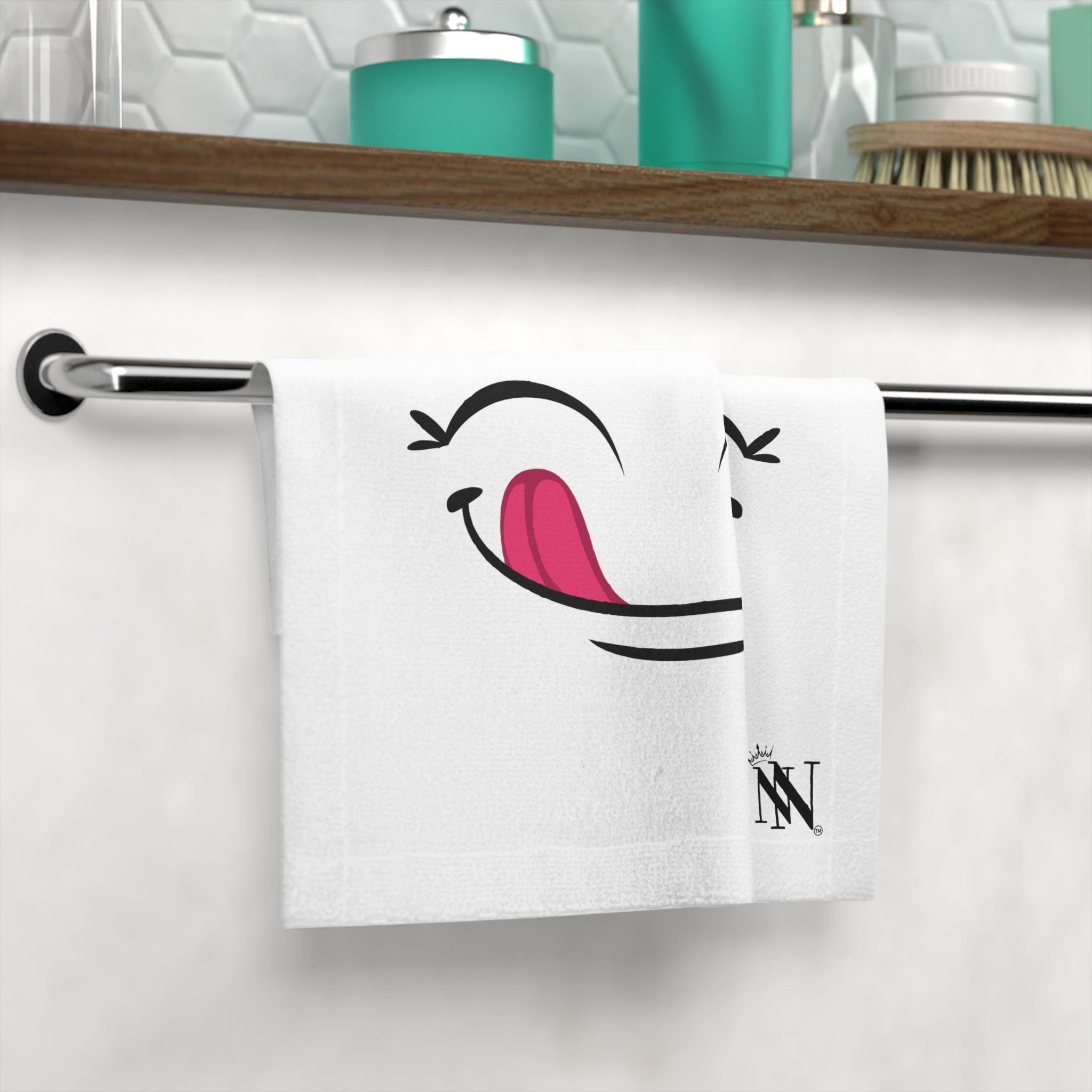 Yummy! After-Sex Cum Towel hanging on a bathroom towel rack, featuring a cheeky winking face design. A fun and sexy addition to intimate essentials.