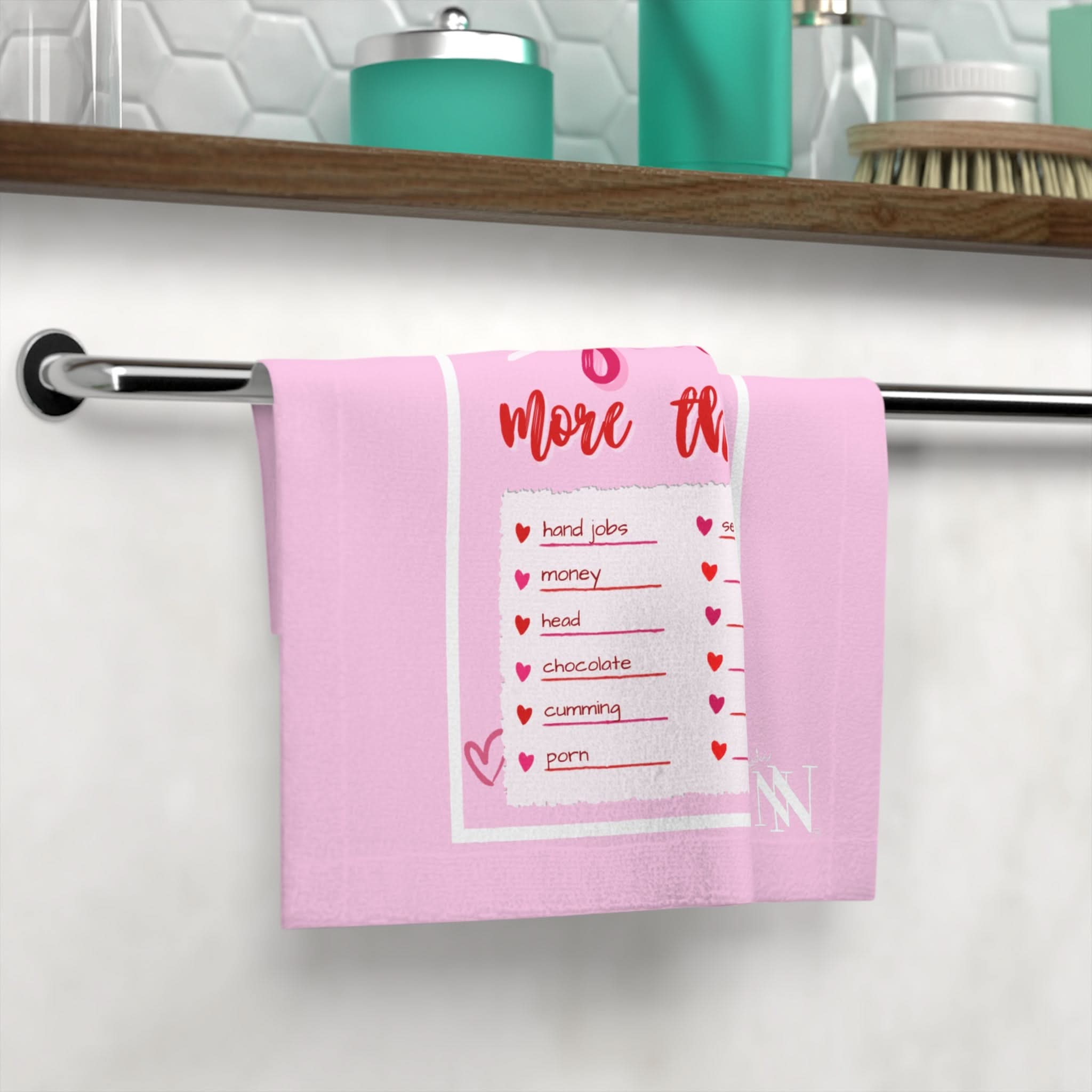 Pink hand towel with playful text 'I Love You More Than' and a checklist design, perfect for flirty and fun intimate moments. Ideal for couples as a sexy and cheeky gift.