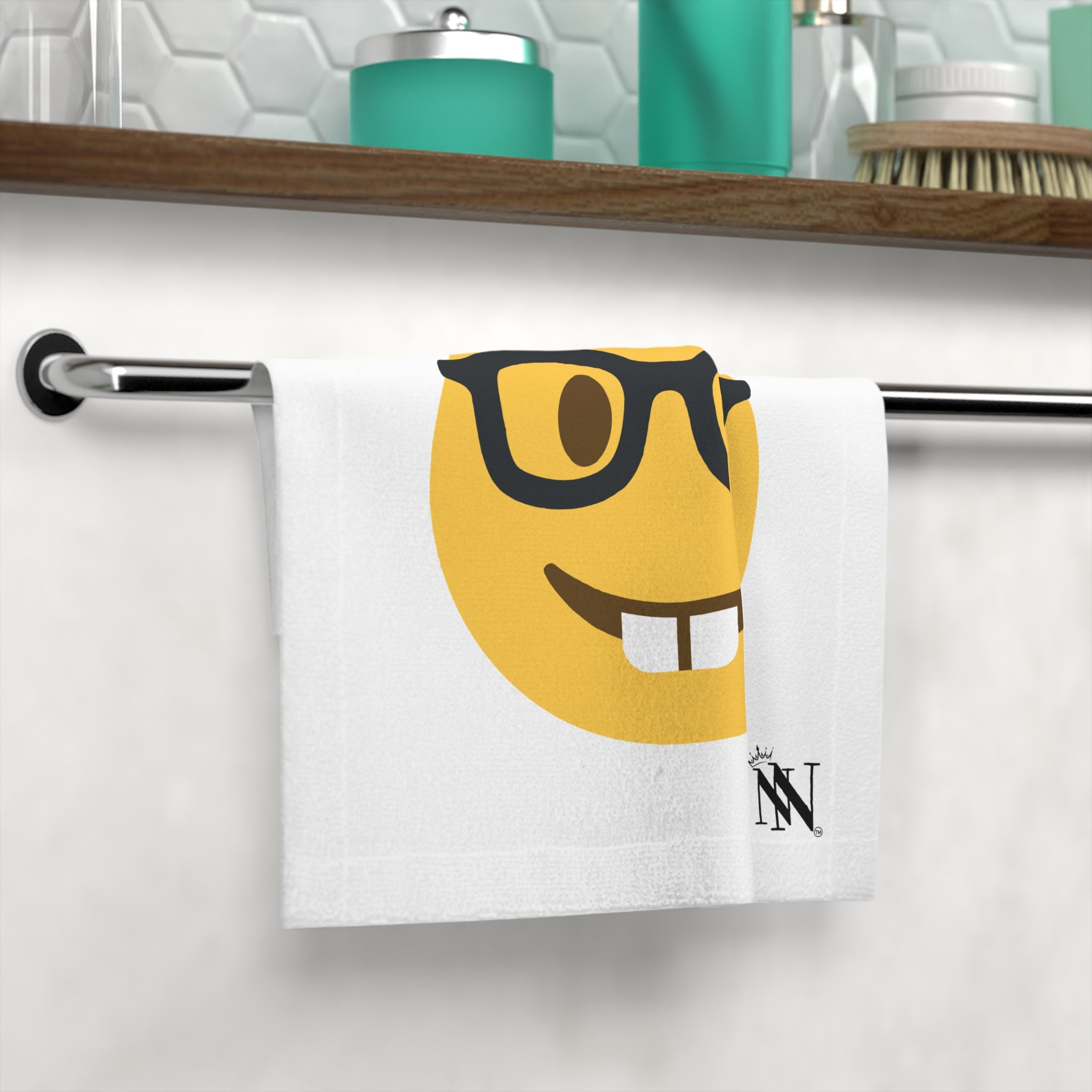 Sexy Nerd Emoji After-Sex Cum Towel featuring a playful nerd emoji design with glasses and teeth, hanging on a bathroom towel rack. Fun and flirty linen for intimate moments.