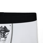 Close-up of white boxer briefs with a pirate skull and crossed swords design, showcasing playful and intimate apparel.