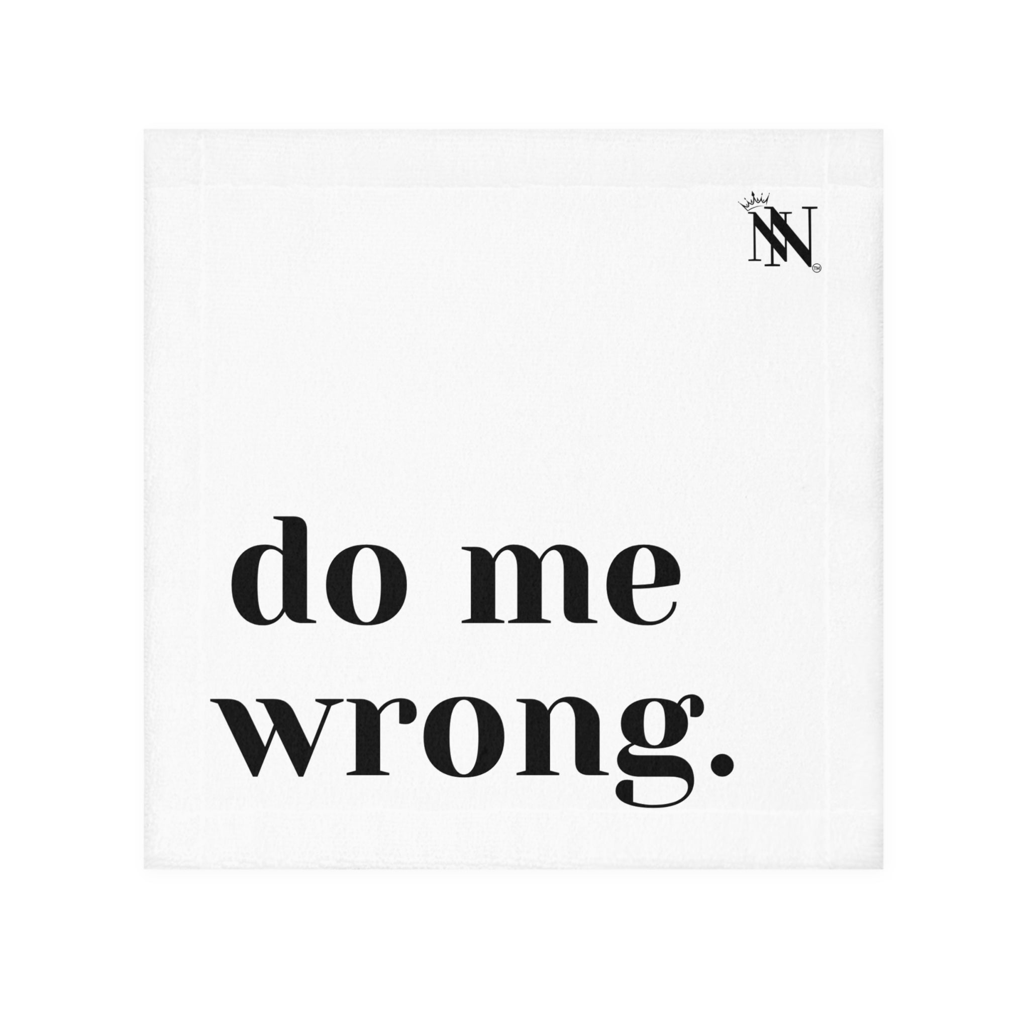 White hand towel with bold black text reading 'do me wrong.' featuring a small crown logo in the corner. Fun and flirty design for intimate moments.